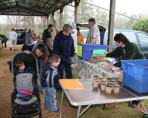 Vicki and Andrea help kids with planting seeds