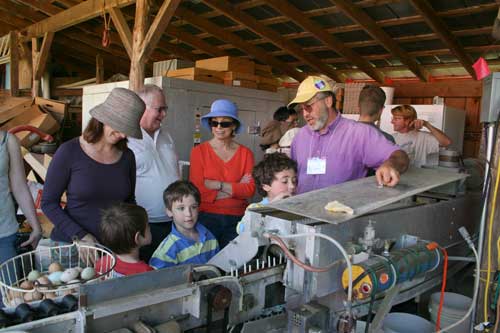 Noah demonstrates the egg-washing machine