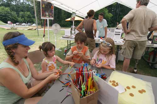 Colleen helps kids make pollinators out of pipe cleaners