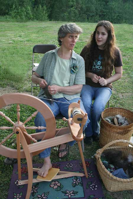 Mary Ann Pagano and her daughter Lily of Three Waters Farm demonstrate how to spin wool 