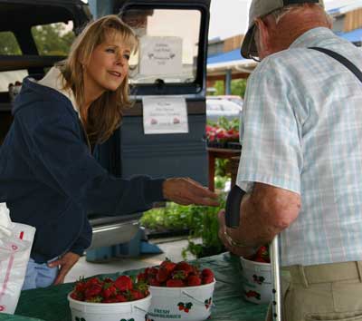 Donna tends to a customer at the Piedmont Triad Farmers' Market. 