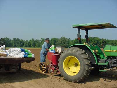 Jimmy fills the hopper with fertilizer before planting sweet corn.