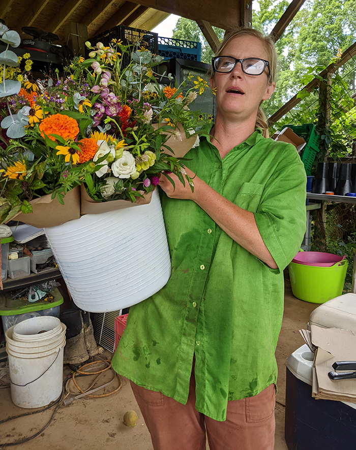 Woman holding a bucket of flower bouquets