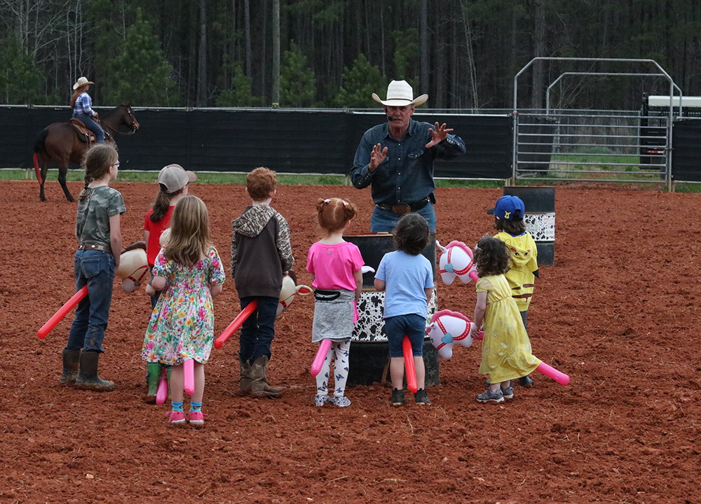 Rodeo entertainer Keith Isley led a stick pony race for the kids.