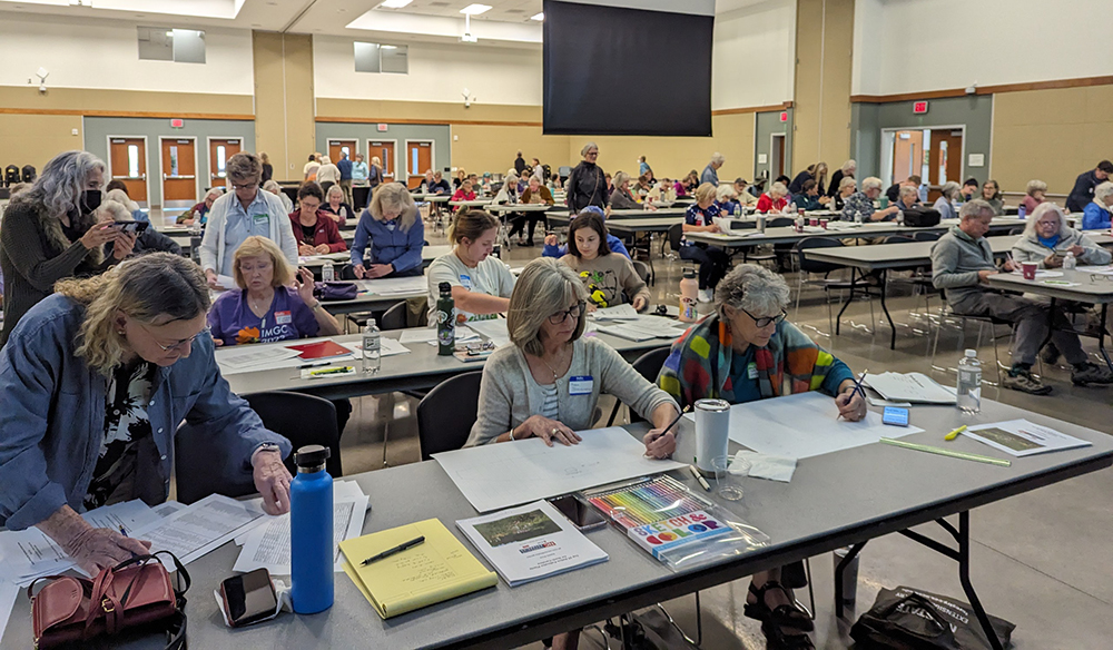 Participants from the Fall 2023 Pollinator Workshop working on their garden designs.