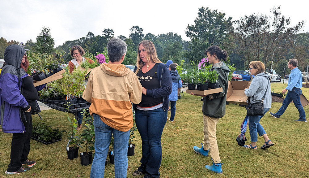 Grower Rachel Nelms assists customers at the Rachel's Native Plants booth.