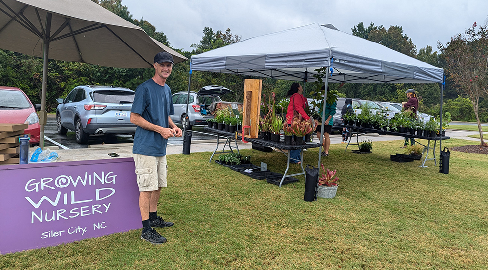 Grower Alistair Glen welcomes shoppers to the Growing Wild Nursery booth.