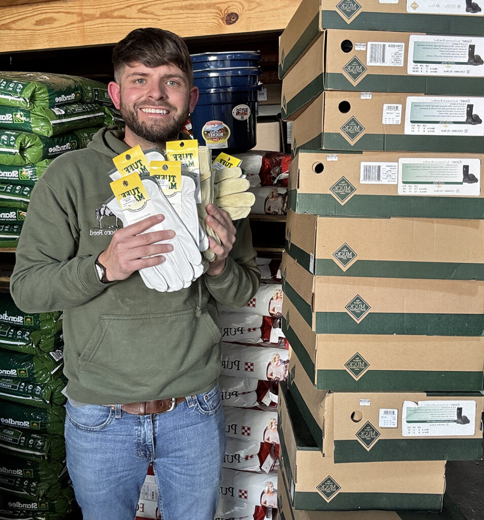 Josh Miller, owner of Pittsboro Feed and Pittsboro Pet Supply, with some of the donated gloves and boots destined for western North Carolina.