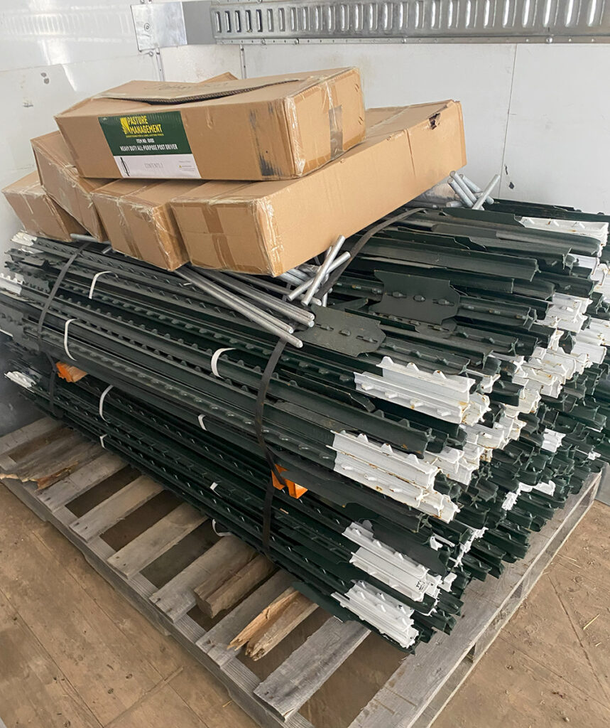 A pallet of T-posts and other fencing supplies.